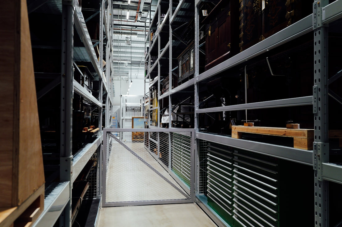 A long aisle between tall storage shelves in a warehouse.